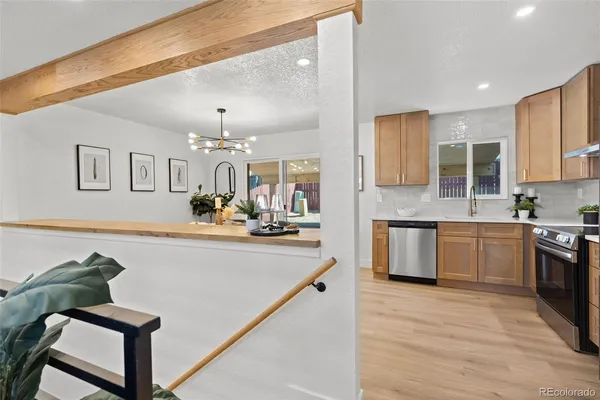 a large kitchen with kitchen island a large counter top space appliances and cabinets