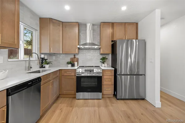 a kitchen with a refrigerator stove and sink