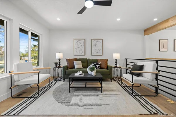 a living room with furniture and a lamp