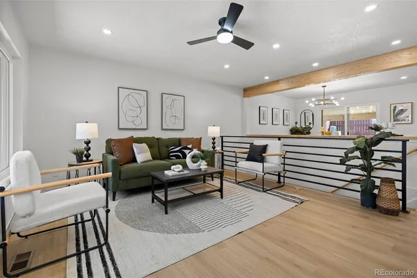 a living room with furniture and wooden floor