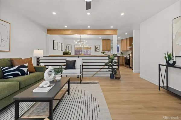 a living room with furniture and wooden floor