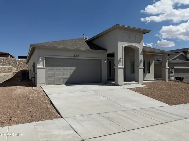 a front view of a house with a garage