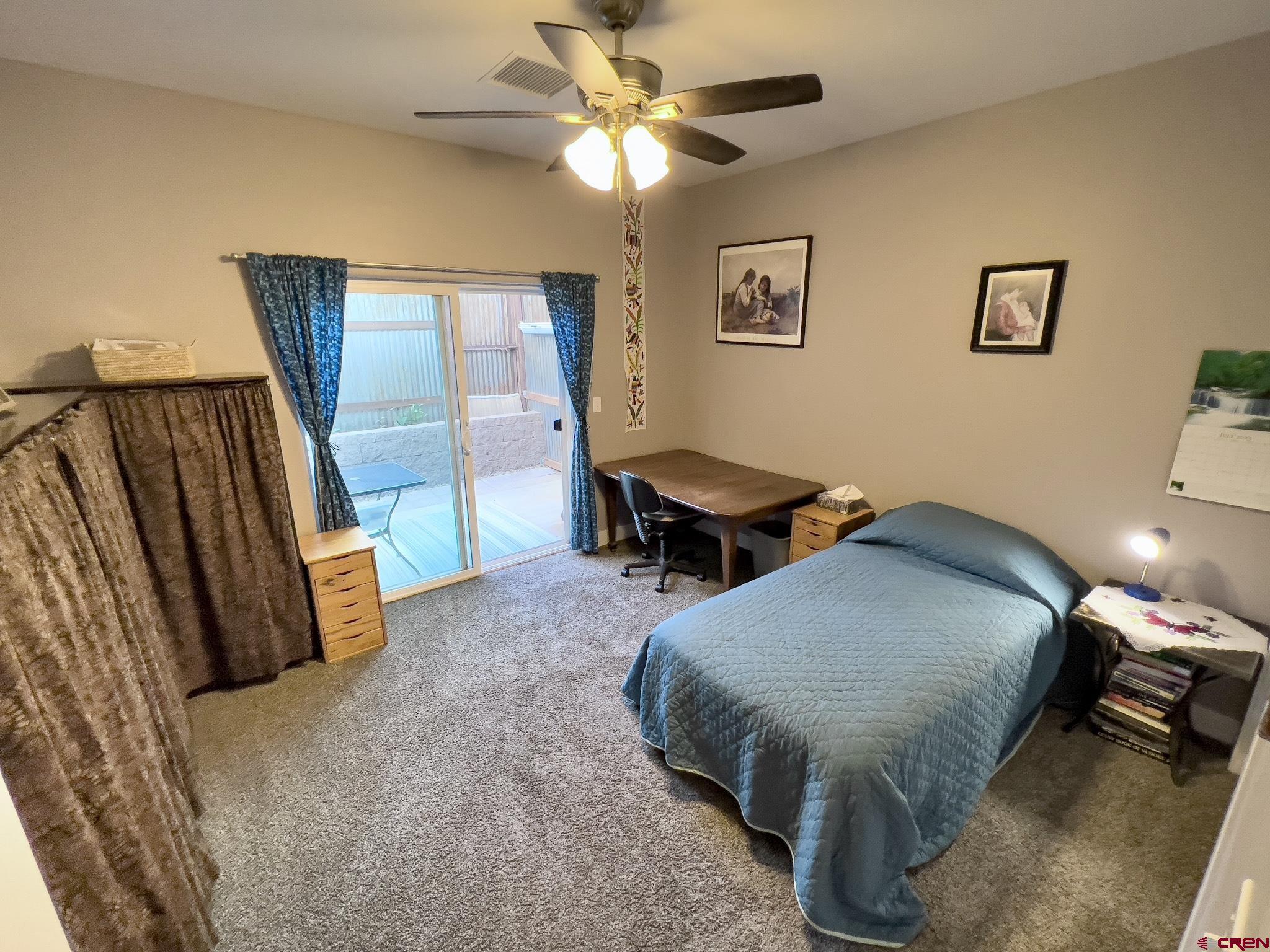 210 West 3rd Street, Unit 2 Cortez, CO 81321 - Photo 11 of 19 a spacious bedroom with a bed and a chandelier