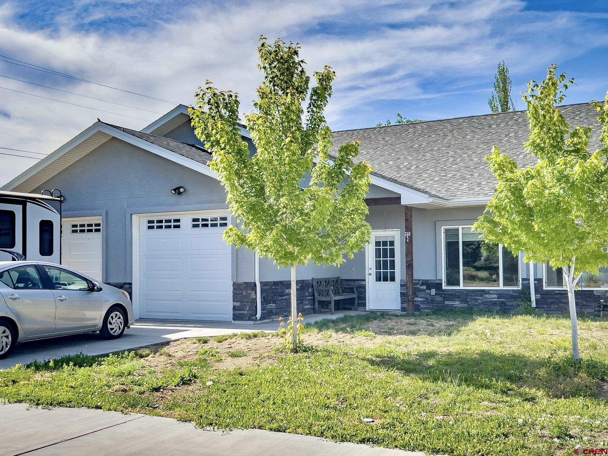 210 West 3rd Street, Unit 2 Cortez, CO 81321 - Photo 16 of 19 a front view of a house with a yard