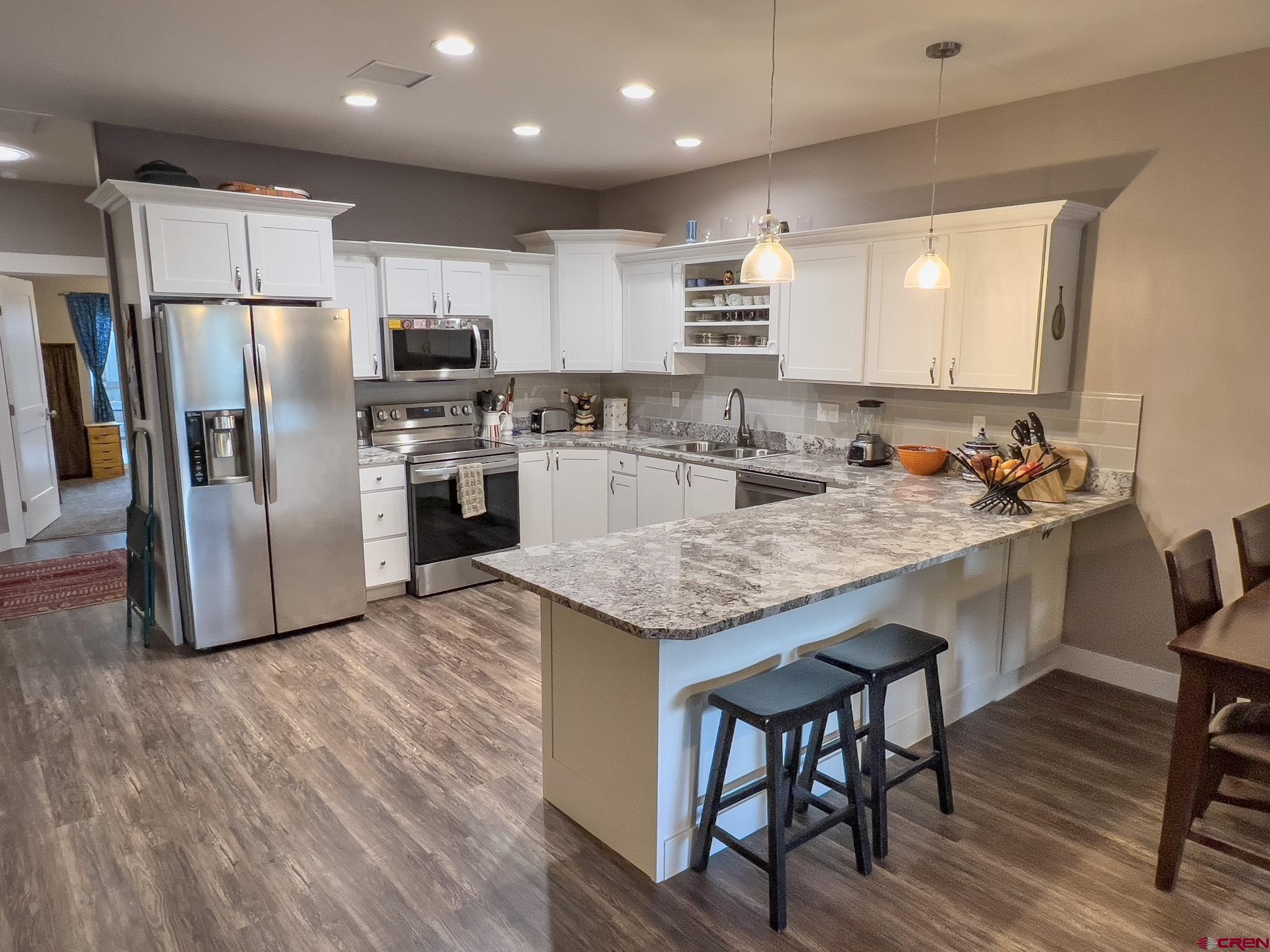 210 West 3rd Street, Unit 2 Cortez, CO 81321 - Photo 3 of 19 a kitchen with granite countertop stainless steel appliances a sink and refrigerator