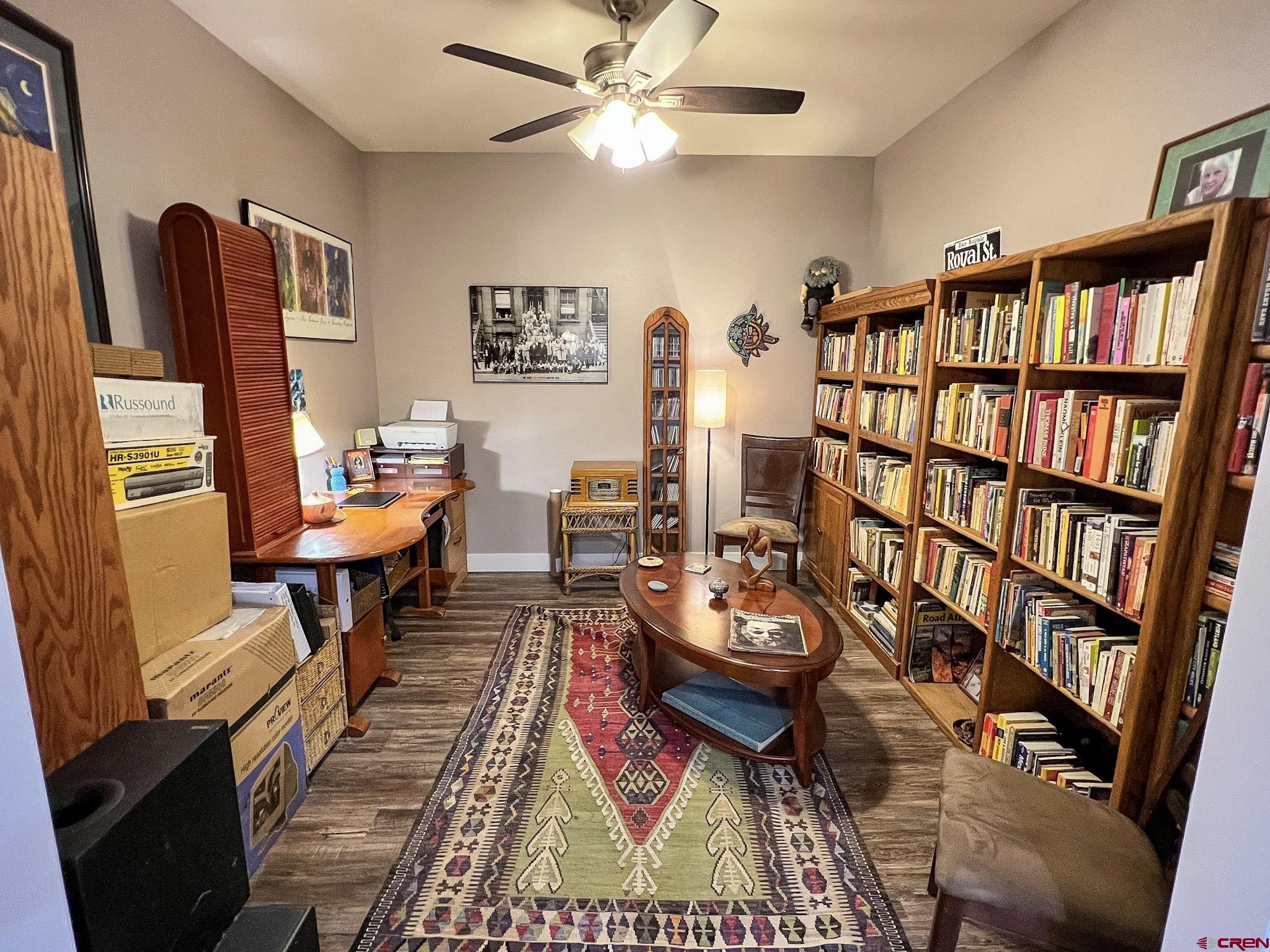 210 West 3rd Street, Unit 2 Cortez, CO 81321 - Photo 7 of 19 a living room with furniture a bookshelf and a bookshelf