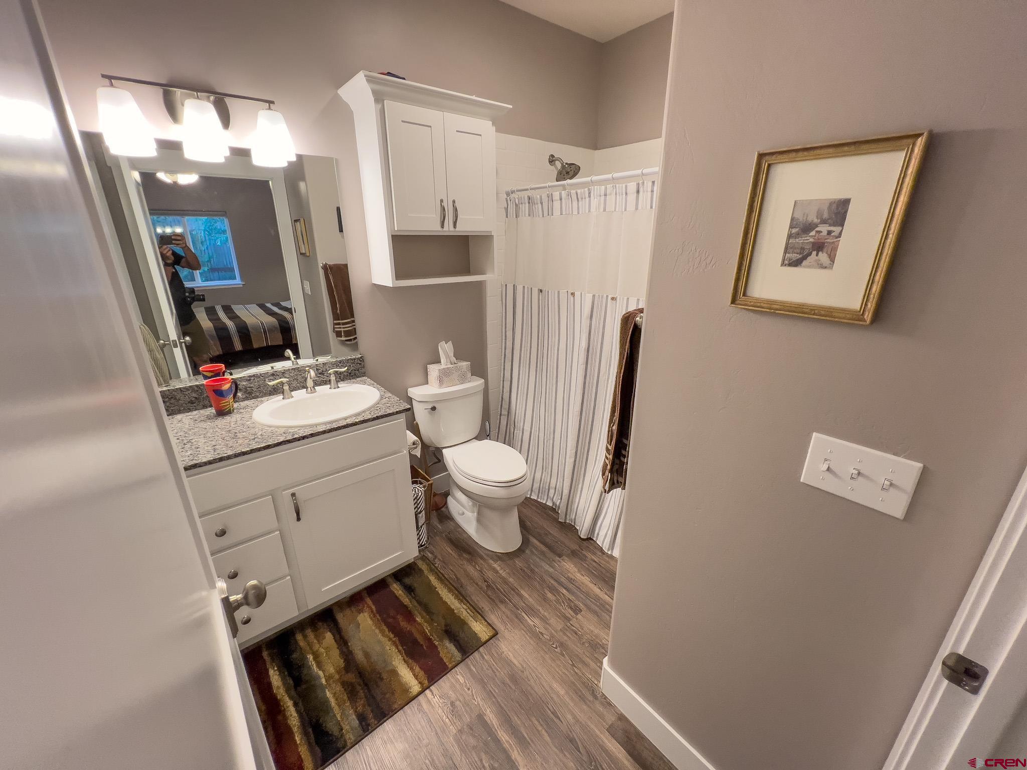 210 West 3rd Street, Unit 2 Cortez, CO 81321 - Photo 8 of 19 a bathroom with a sink toilet and shower