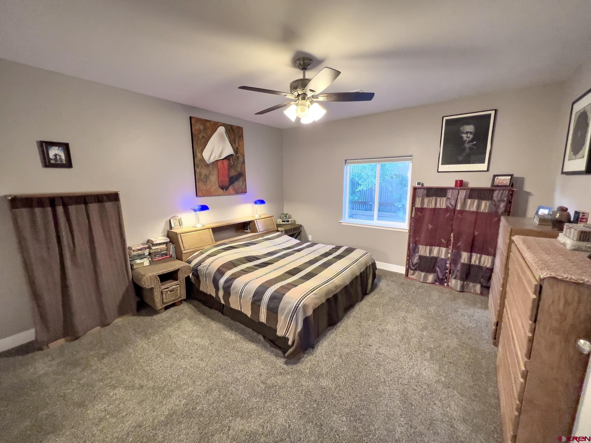 210 West 3rd Street, Unit 2 Cortez, CO 81321 - Photo 9 of 19 a bedroom with bed and wooden floor