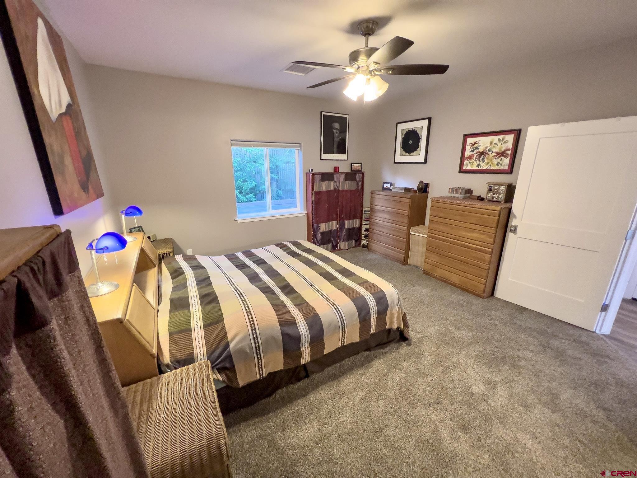 210 West 3rd Street, Unit 2 Cortez, CO 81321 - Photo 10 of 19 a bedroom with a bed and a chandelier