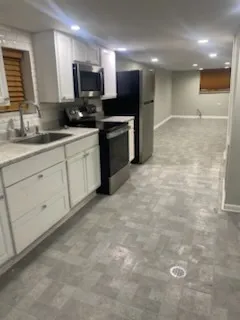 a view of a livingroom with wooden floor and white walls