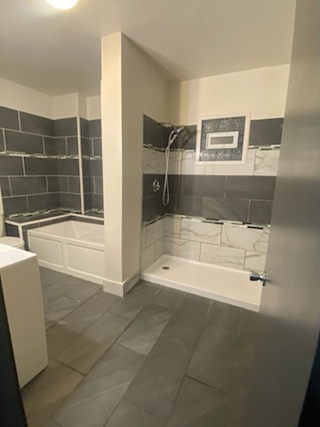 6827 South Green Street Chicago, IL 60621 - Photo 20 of 24 a bathroom with a bathtub and a shower