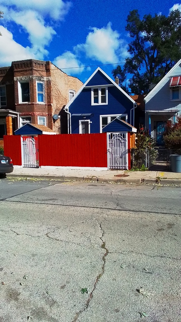 6827 South Green Street Chicago, IL 60621 - Photo 2 of 24 a front view of a house with a yard