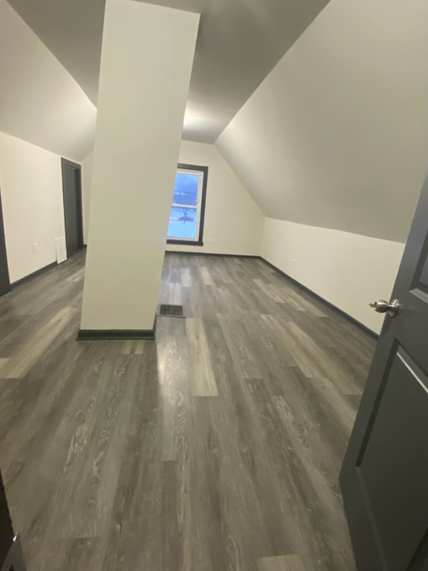 6827 South Green Street Chicago, IL 60621 - Photo 23 of 24 a view of an empty room and wooden floor