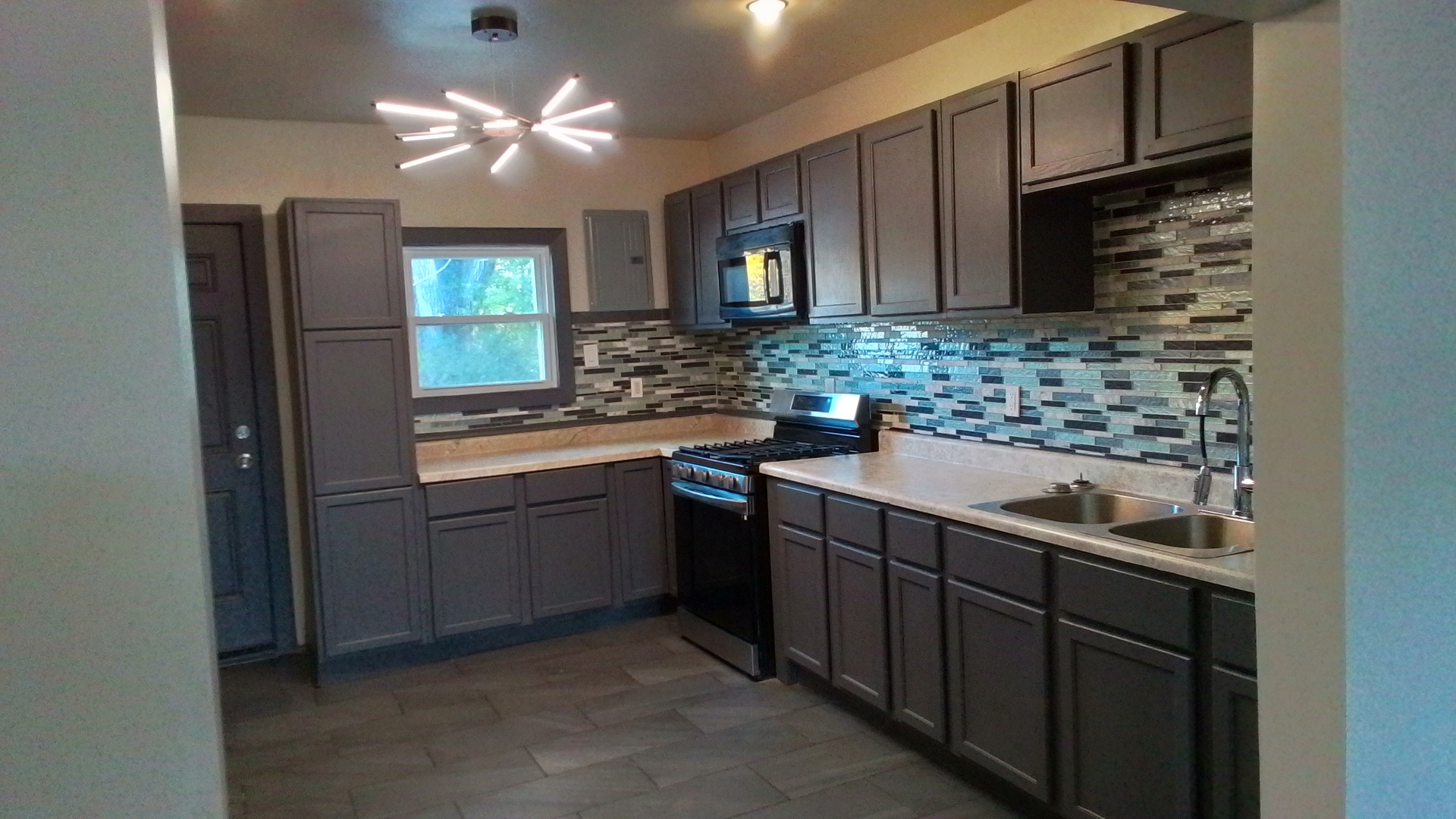 6827 South Green Street Chicago, IL 60621 - Photo 7 of 24 a kitchen with a sink and cabinets