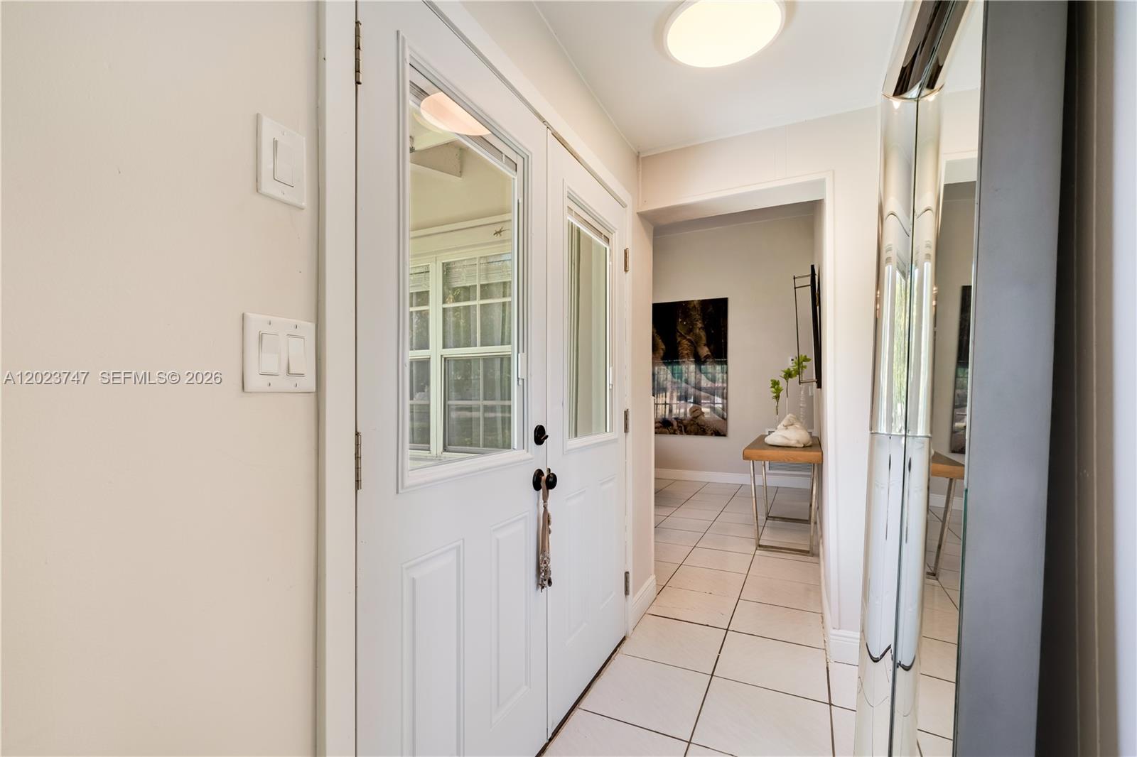 11515 Southwest 81st Road, Unit 11515 Pinecrest, FL 33156 - Photo 28 of 33 a view of a hallway with wooden floor and windows