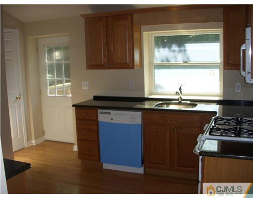 61 Major Road Monmouth Junction, NJ 08852 - Photo 2 of 12 a kitchen that has a sink and a stove
