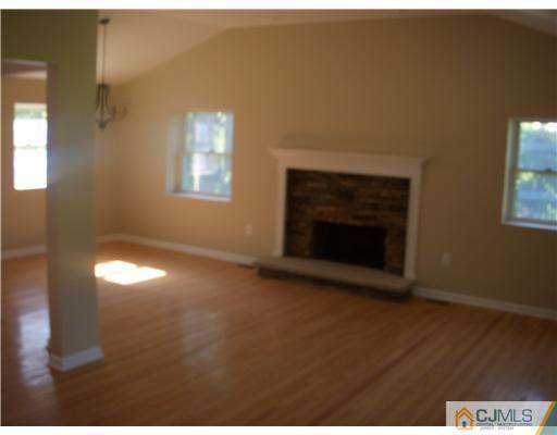 61 Major Road Monmouth Junction, NJ 08852 - Photo 3 of 12 a view of empty room with a fireplace