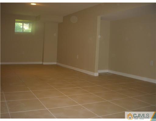 61 Major Road Monmouth Junction, NJ 08852 - Photo 10 of 12 a bathroom with a glass door shower and a bathtub