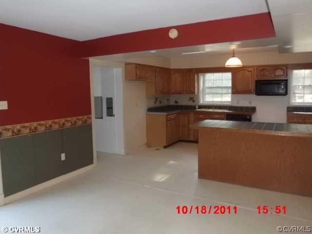 12309 Crumpland Road Chesterfield, VA 23832 - Photo 5 of 12 a kitchen with granite countertop a sink and a stove top oven