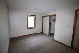 132 Tyngsboro Road, Unit 1 North Chelmsford, MA 01863 - Photo 6 of 16 an empty room with windows