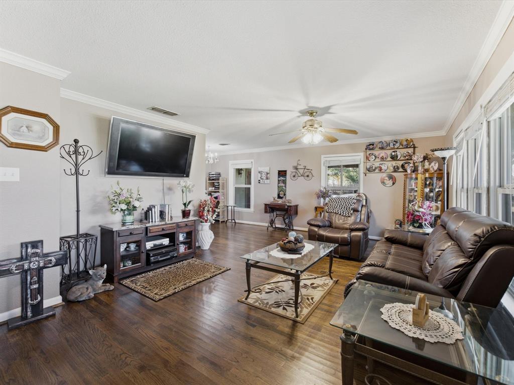 301 Ovilla Road Waxahachie, TX 75167 - Photo 10 of 38 a living room with furniture and a flat screen tv with wooden floor