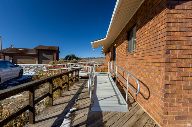 1208 East Tidwell Road Loa, UT 84747 - Photo 12 of 40 View of home's exterior with brick siding and a deck