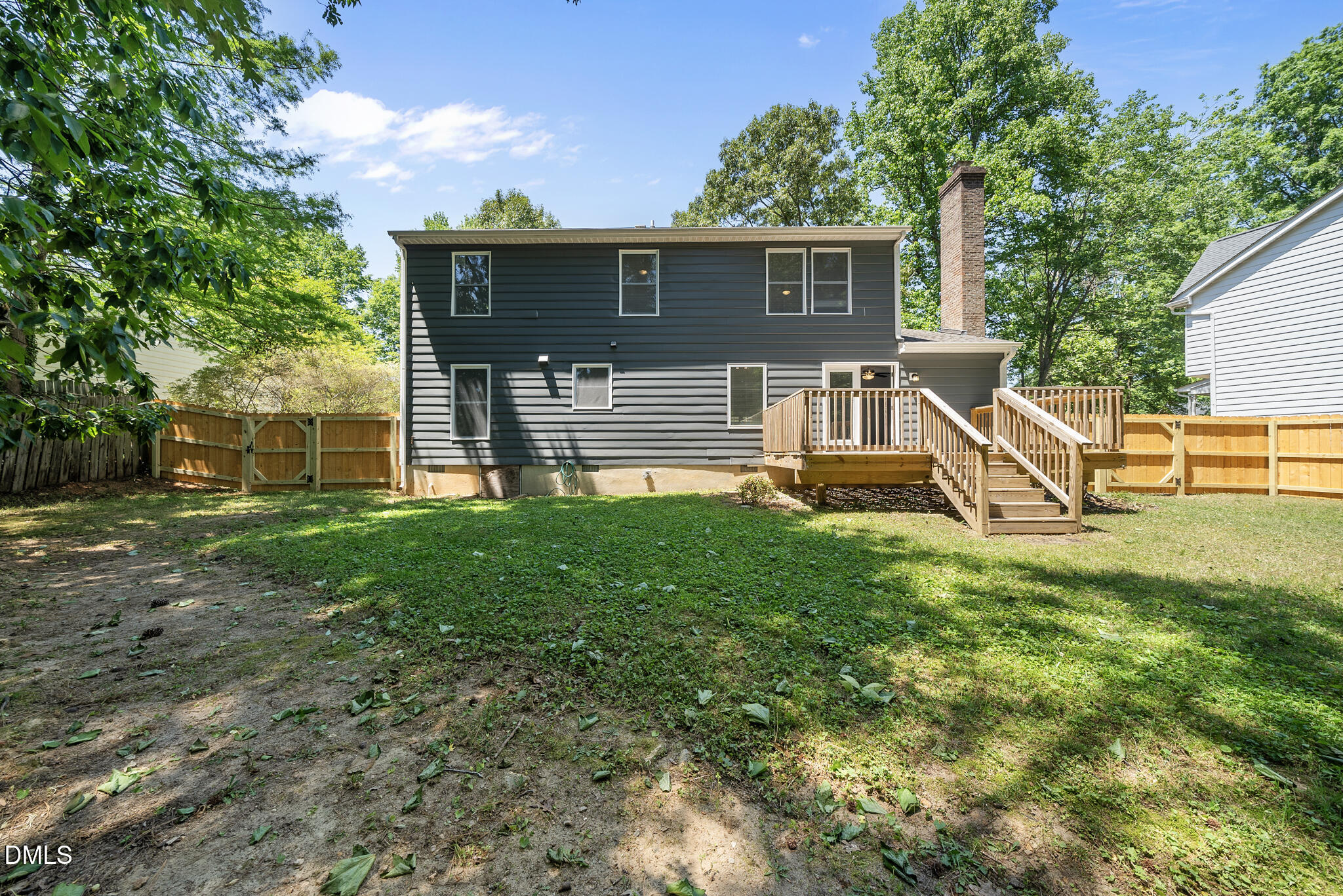 2108 Treverton Place Raleigh, NC 27609 - Photo 24 of 30 a view of a house with backyard and a wooden fence