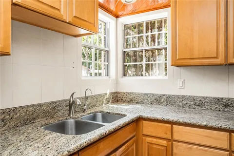a kitchen with granite countertop a sink and a window