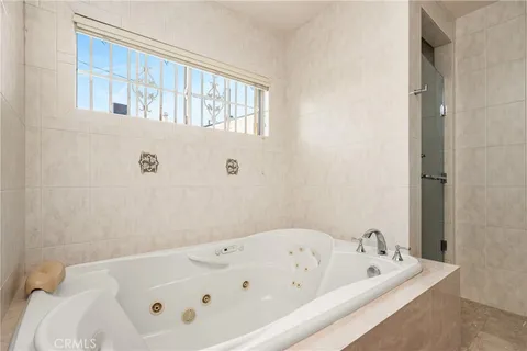 a bathroom with a tub and a window
