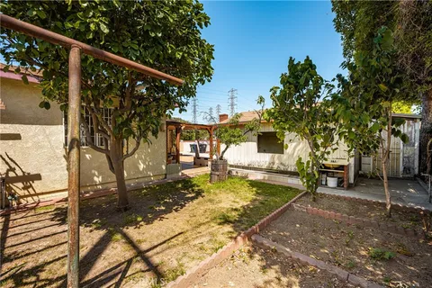 a view of a patio with a table chairs and a small yard