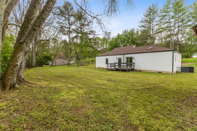 a view of a house with a yard and sitting area