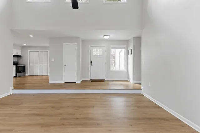 a view of empty room with wooden floor