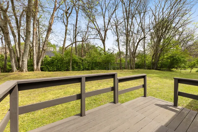 a view of backyard with large trees