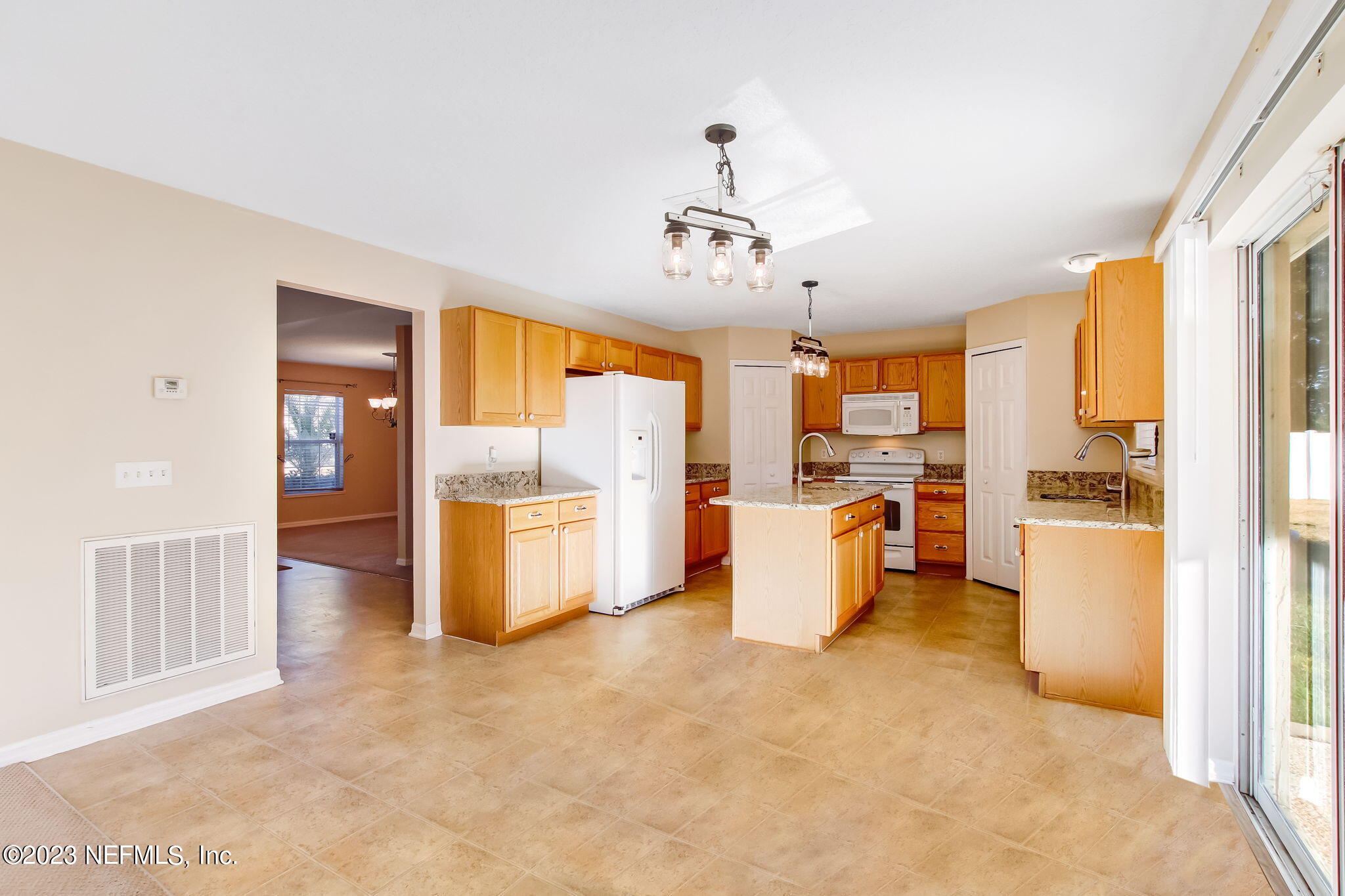 54005 Turning Leaf Drive Callahan, FL 32011 - Photo 11 of 54 a view of a kitchen with furniture and a kitchen view
