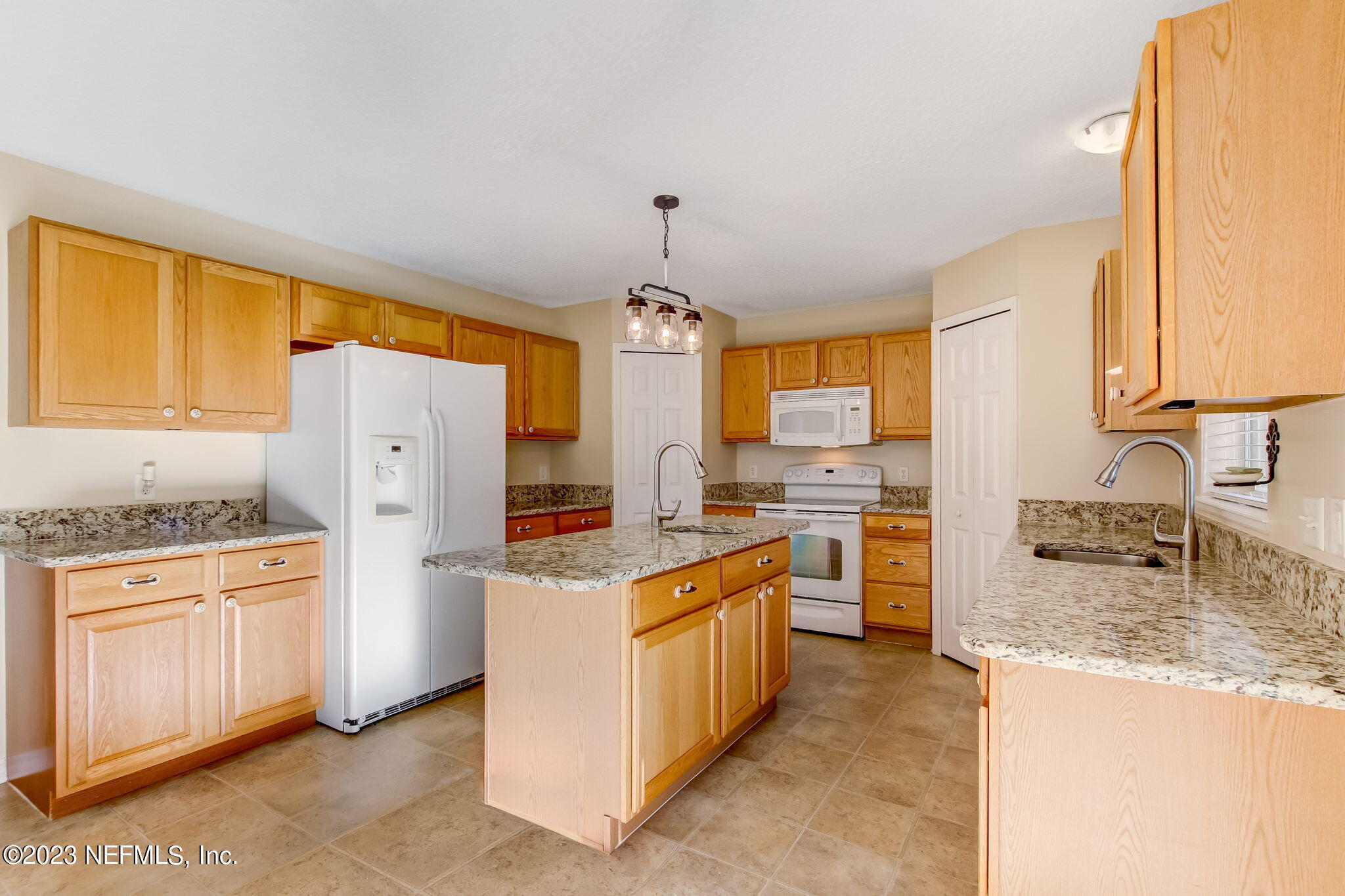 54005 Turning Leaf Drive Callahan, FL 32011 - Photo 13 of 54 a kitchen with a refrigerator stove and sink