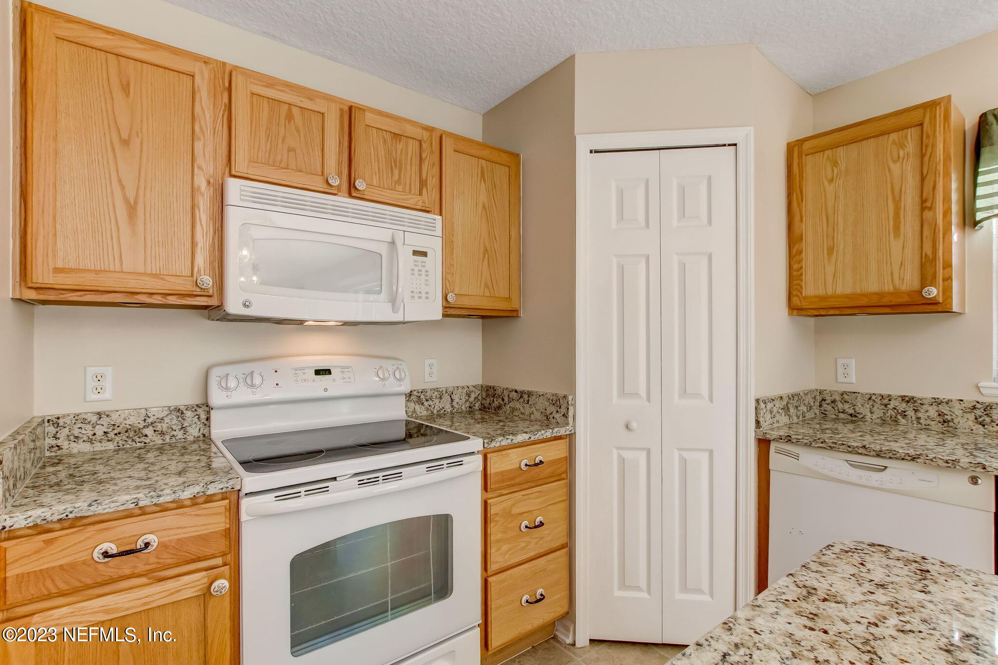 54005 Turning Leaf Drive Callahan, FL 32011 - Photo 17 of 54 a kitchen with granite countertop cabinets stainless steel appliances and sink