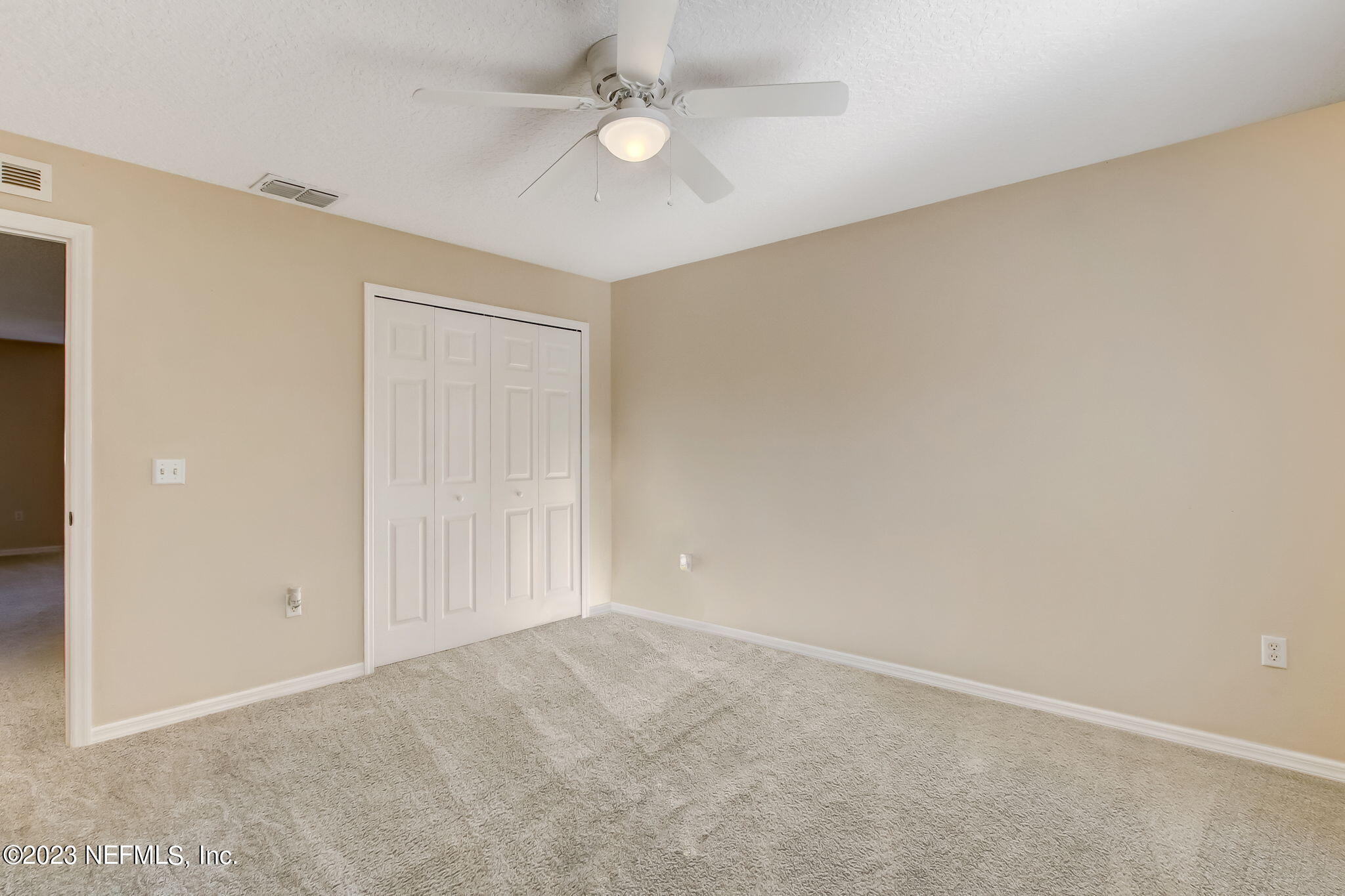 54005 Turning Leaf Drive Callahan, FL 32011 - Photo 32 of 54 an empty room with a ceiling fan and a window