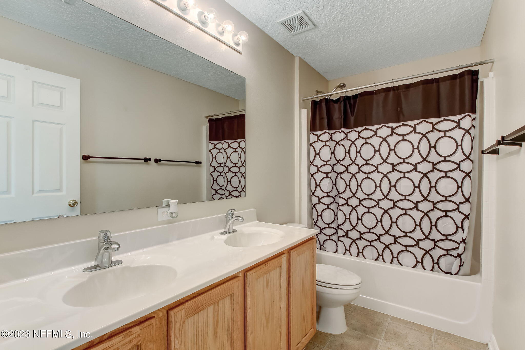 54005 Turning Leaf Drive Callahan, FL 32011 - Photo 35 of 54 a bathroom with a sink and a mirror