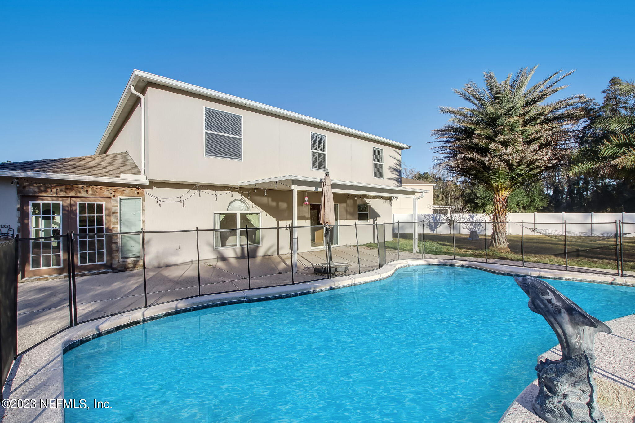 54005 Turning Leaf Drive Callahan, FL 32011 - Photo 51 of 54 a view of a house with pool and chairs next to yard