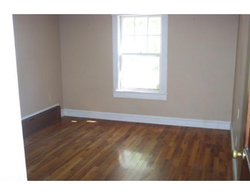 79 Mattapoisett Road Rochester, MA 02770 - Photo 13 of 16 a view of an empty room with wooden floor and a window