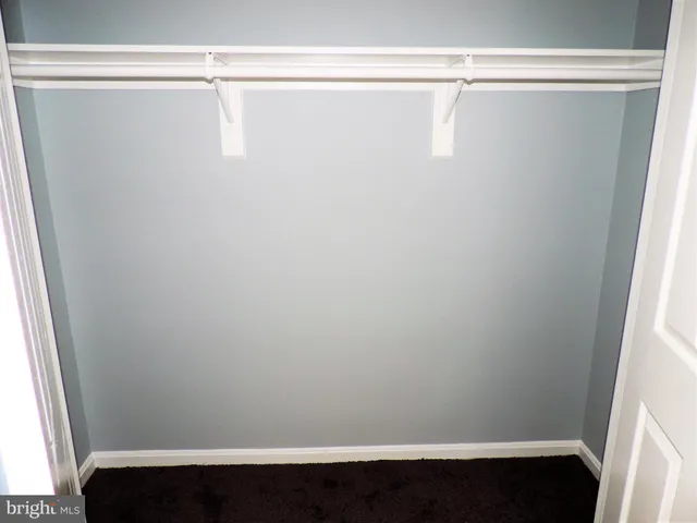 a view of a closet with wooden floor