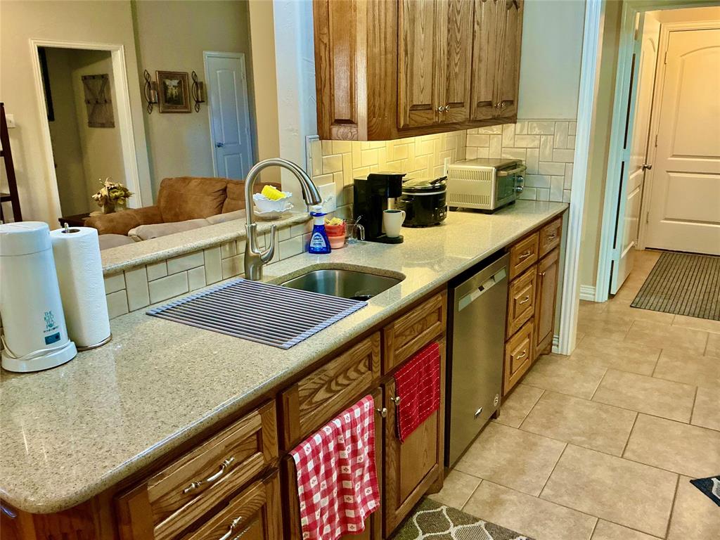 312 McAfee Street Mabank, TX 75147 - Photo 21 of 40 a kitchen with granite countertop lots of counter space and sink