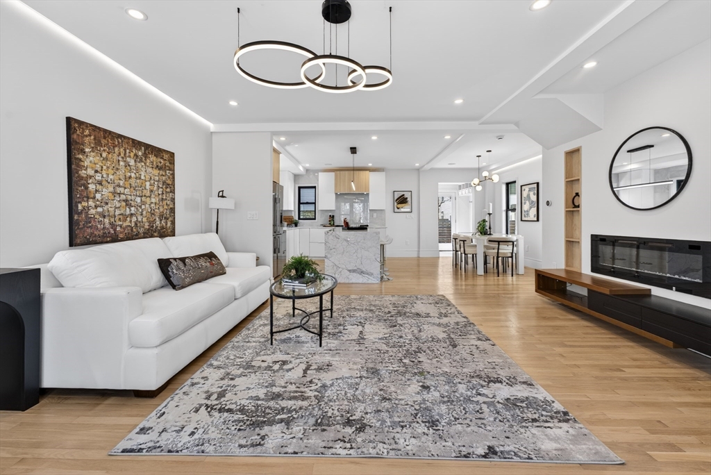 29 Line Street Cambridge, MA 02138 - Photo 19 of 42 a living room with furniture wooden floor and a table