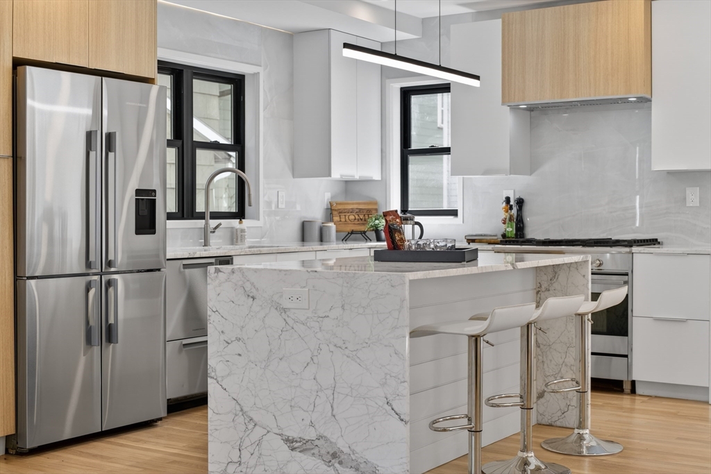29 Line Street Cambridge, MA 02138 - Photo 2 of 42 a kitchen with stainless steel appliances granite countertop a refrigerator and a sink