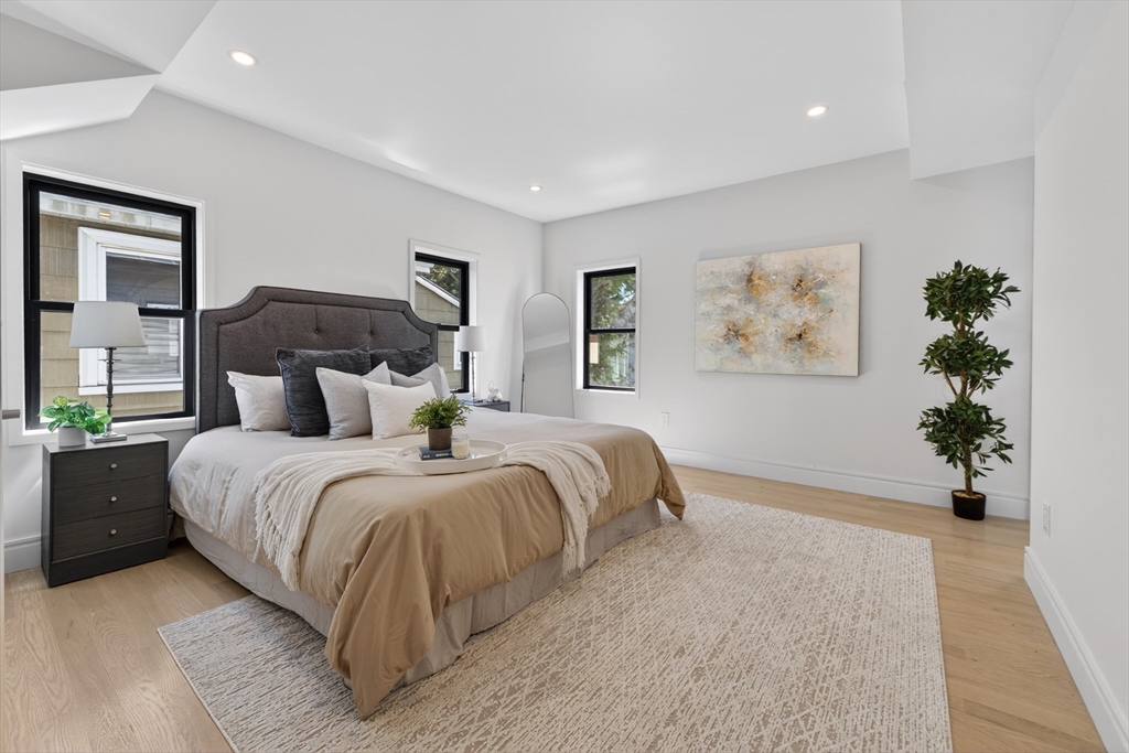 29 Line Street Cambridge, MA 02138 - Photo 22 of 42 a spacious bedroom with a large bed and a potted plant