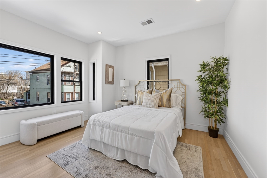 29 Line Street Cambridge, MA 02138 - Photo 23 of 42 a bedroom with a large bed and a large window