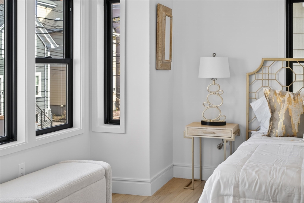 29 Line Street Cambridge, MA 02138 - Photo 24 of 42 a bedroom with a bed and a night stand