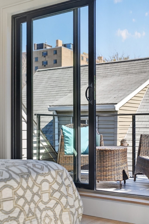 29 Line Street Cambridge, MA 02138 - Photo 25 of 42 a view of a living room filled with furniture and a window