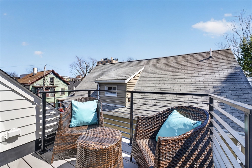 29 Line Street Cambridge, MA 02138 - Photo 28 of 42 a view of a roof deck with wooden floor and seating space