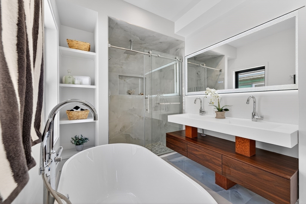 29 Line Street Cambridge, MA 02138 - Photo 34 of 42 a room with two couches and dinning table with wooden floor